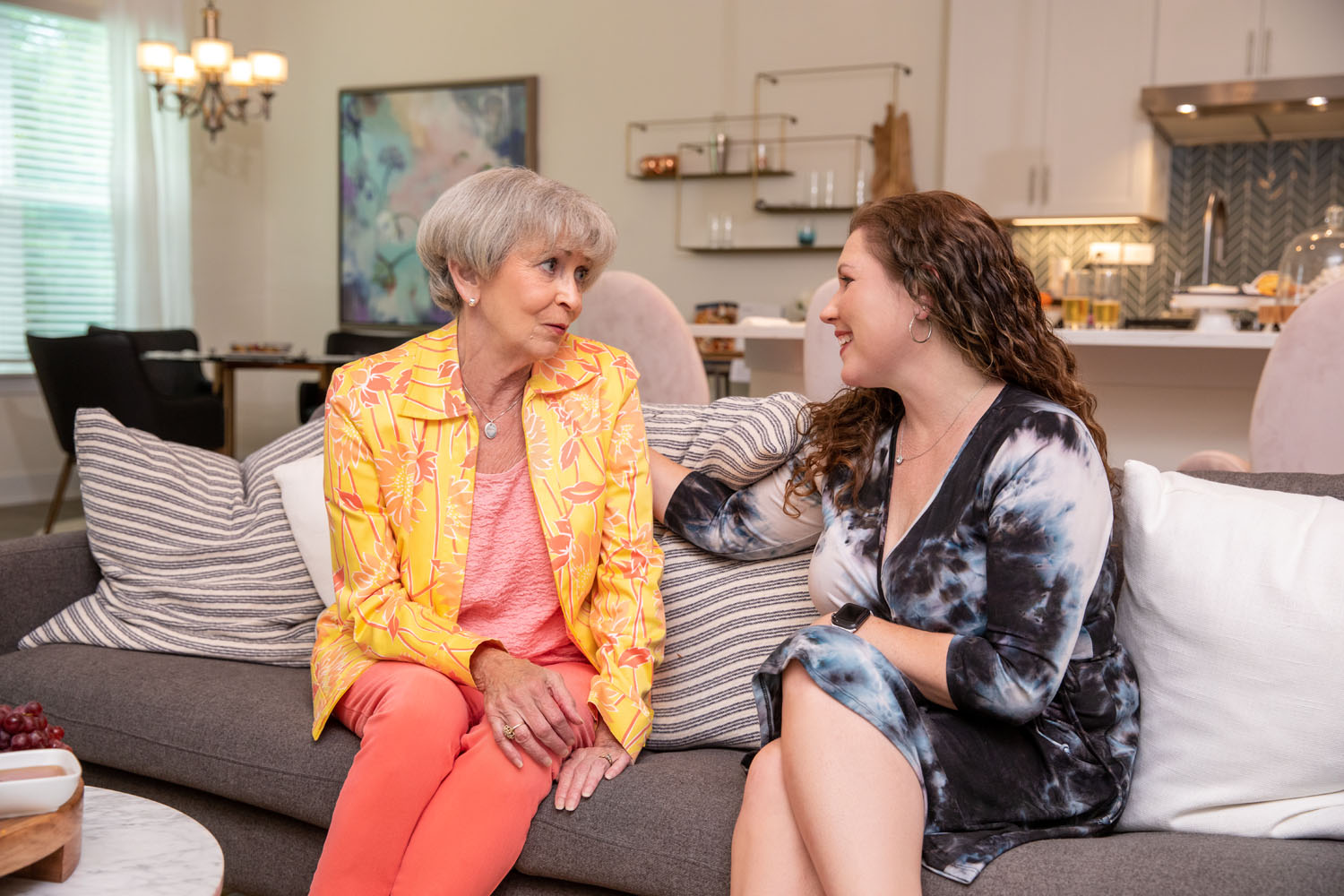 arbor terrace resident and family member talking on couch