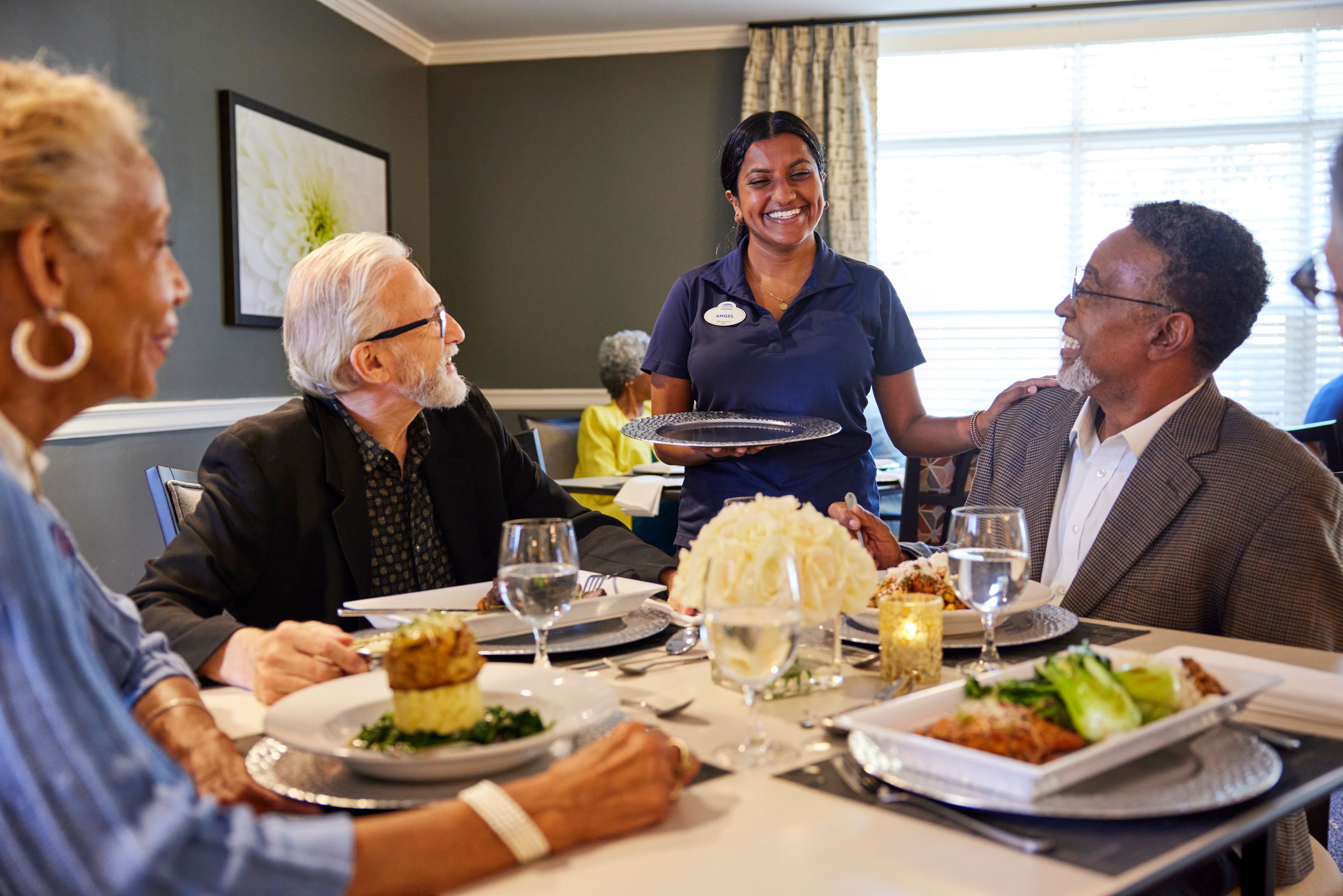 arbor terrace residents enjoying meal with staff
