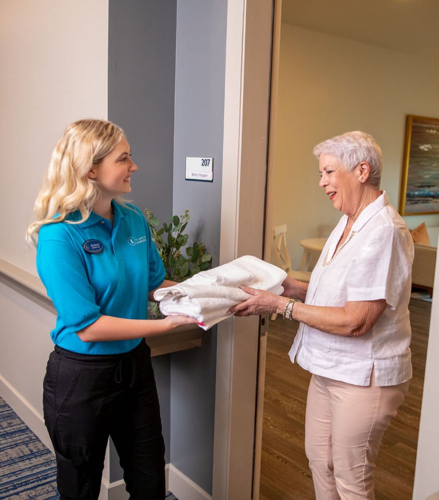 arbor terrace laundry staff giving towels to residents