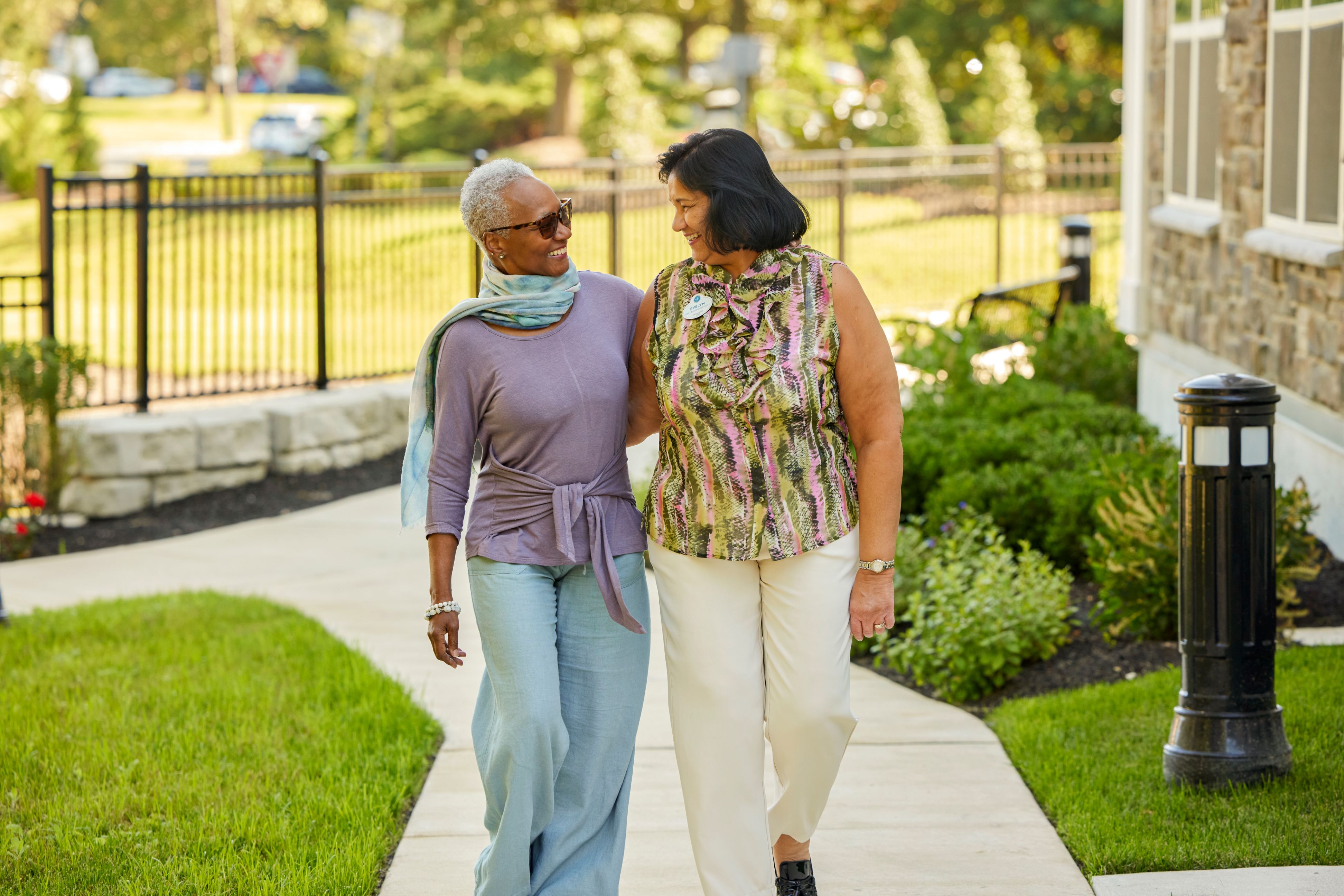 arbor terrace resident and staff talking outdoors